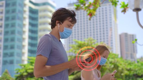 Concept of a contact tracing app for coping with COVID-19 Pandemic. Man gets a notification that potentially dangerous person walks nearby. Smartphones exchange data about social contacts of its