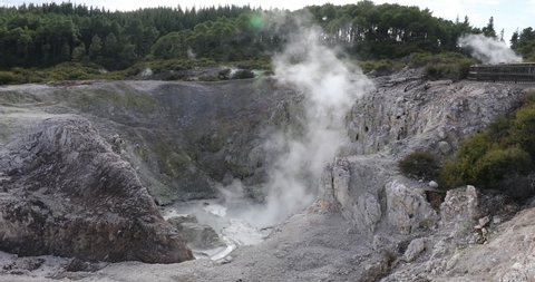 4K right to left panning motion of boiling mud and water at bottom of a Fumarole crater at Wai-O-Tapo Thermal Wonderland near the town of Rotorua,North Island,New Zealand