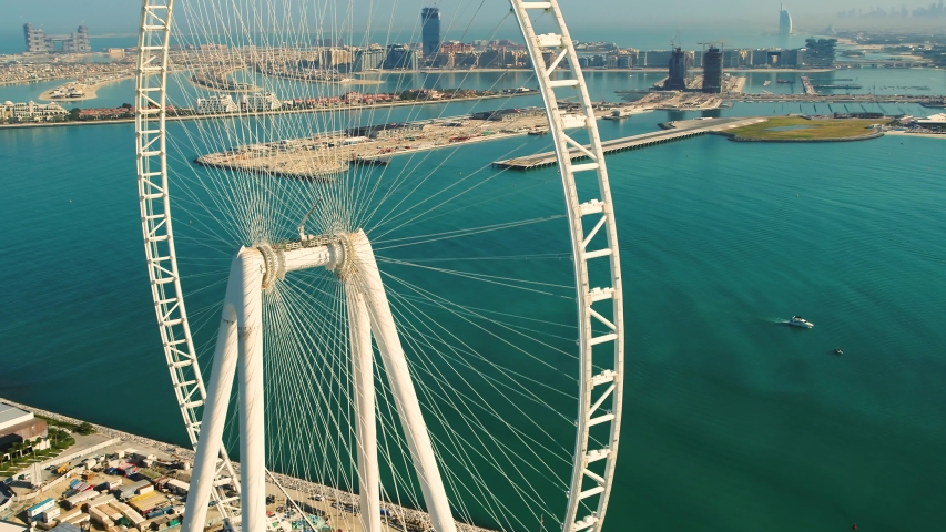 Aerial view of the Ferris wheel under construction on Bluewaters island in Dubai. | Shutterstock HD Video #1053231662