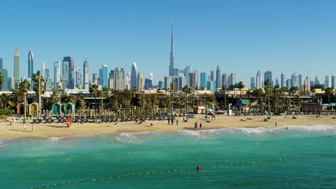 Aerial view of a luxury beach with Dubai skyscrapers at the background, U.A.E.