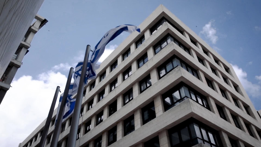 State Flag of Israel. The Big Flag flutter epically in the wind against the bricks wall. National simbol. Jerusalem