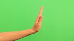 Sign NO and COME on green screen background. Closeup view of one single male hand making no gesture isolated on greenscreen chromakey background. - Powered by Shutterstock - Get 15% off with code: PIKWIZARD15