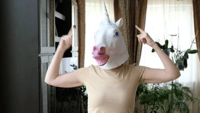 Funny weird video - woman dancing in unicorn mask head at home