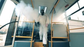 Sanitation worker disinfects bus with a sprayer. - Powered by Shutterstock - Get 15% off with code: PIKWIZARD15