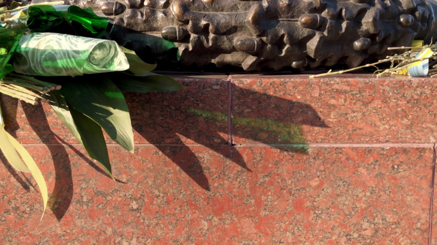 Camera rises to reveal the eternal flame at the Monument to the Unknown Sailor in Shevchenko Park, Odessa Ukraine