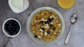 Pouring Milk on Cereal with Blueberries