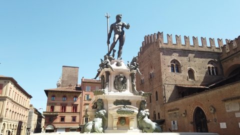 Neptune 1500s bronze statue fountain with gothic architecture background in Piazza Maggiore central square of Bologna town in Italy.