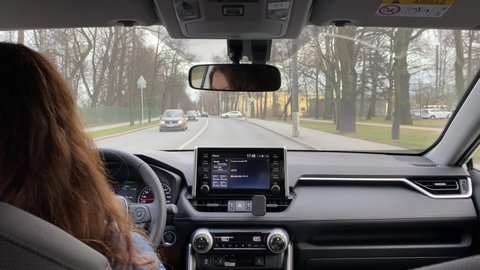 SAINT PETERSBURG, RUSSIA - CIRCA APRIL 2020: Female driver driving her car, woman behind the wheel of Toyota RAV4 compact crossover SUV.