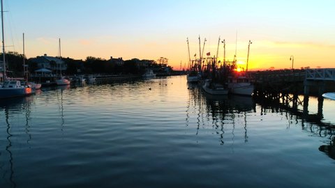 Shrimp Boats reflecting in the water at sunset. Filmed at Shem Creek in Mount Pleasant, SC. Just outside of Charleston, South Carolina.