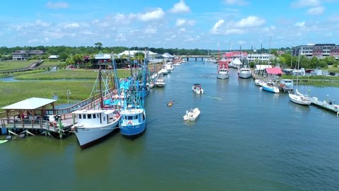 Shrimp Boats in creek during the daytime. Filmed at Shem Creek in Mount Pleasant, SC. Just outside of Charleston, South Carolina.