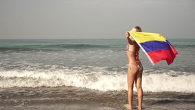 Woman with Colombia flag at sea. Girl with a Colombian flag on the beach - Powered by Shutterstock - Get 15% off with code: PIKWIZARD15