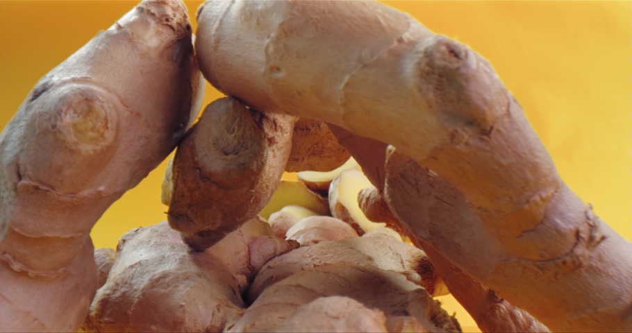 Close up of camera moving inside a pile of fresh ginger. Macro wide shot on Laowa, Red Dragon. | Shutterstock HD Video #1053266726