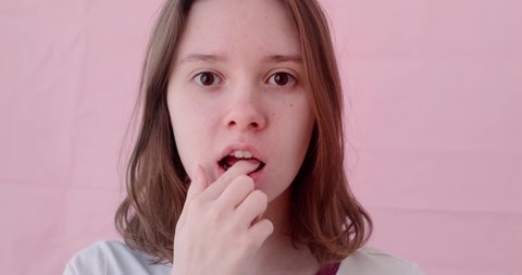 the girl inserts mouth guards to correct the bite close up