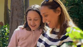 CU Mother and daughter (10-11) looking at smart phone on backyard / Florence, Tuscany, Italy - Powered by Shutterstock - Get 15% off with code: PIKWIZARD15