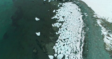 AERIAL MS Beached brash ice at coast of Mikkelsen Harbor / Antarctic Peninsula, Antarctica