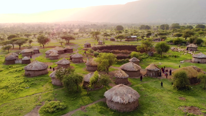 Aerial Drone Shot. Traditional Masai village at Sunset time near Arusha, Tanzania. Royalty-Free Stock Footage #1053275867