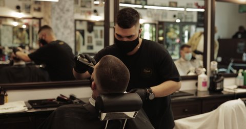 The master makes the contour of the haircut. Men's haircut in a barbershop. Slow motion 4k