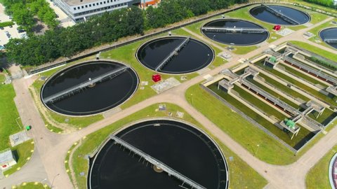 Wide aerial of water purification circle, clean drinking water. Ecosystem of filtration, fresh water and watermanagement. Sewage treatment plant in the sun. 