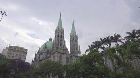 View of Se Cathedral, with imperial palms at the front and blue sky. Sao Paulo. Brazil. 15 march, 2019. Cripta da Catedral da Se. 4k video. Part2