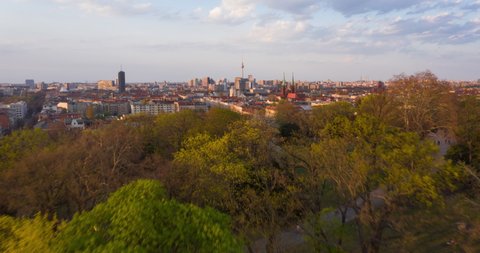 AERIAL: Beautiful Sunset Drone Hyper Lapse, Motion Time Lapse over Berlin Cityscape with Alexanderplatz TV Tower view and Blue Sky with Clouds
