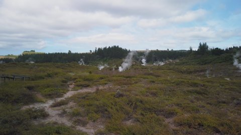 4k left to right panning view of steaming vents at the Craters of the Moon thermal park area which has a lot of geothermal steam activity, Taupo, North Island, New Zealand