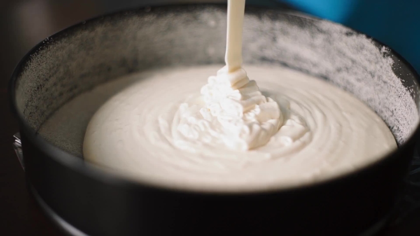 Baker pours batter into the form for baking | Shutterstock HD Video #1053293444
