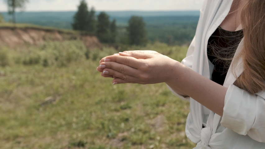 Girl holding a butterfly in her hands, fly away