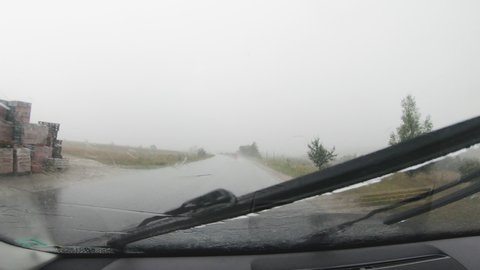 Drive car in rain storm on curve asphalt wet road.