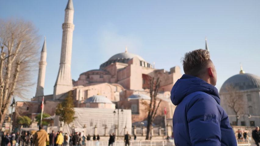 Tourist on the background of Hagia Sophia in Istanbul.