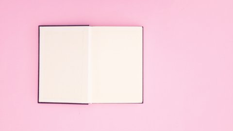 Purple book opens on pink background - Stop motion	
