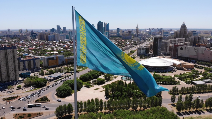 The flag of Kazakhstan is developing in the wind.Astana - Nur Sultan.Drone shooting.