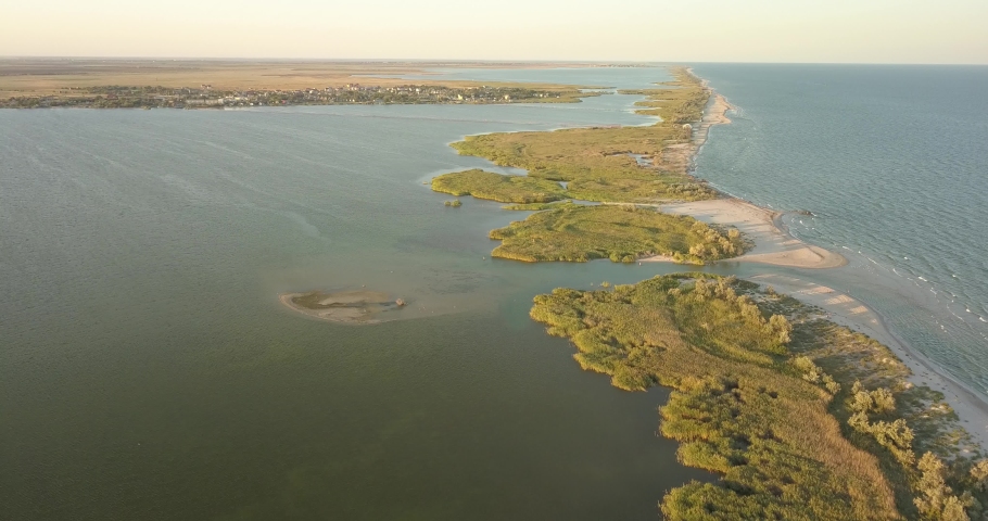 Aerial view to Sasyk Lagoon and resort Katranka at Tuzly Estuary National Nature Park near by Black Sea coast at golden hour, Tatarbunary region, Bessarabia, Ukraine