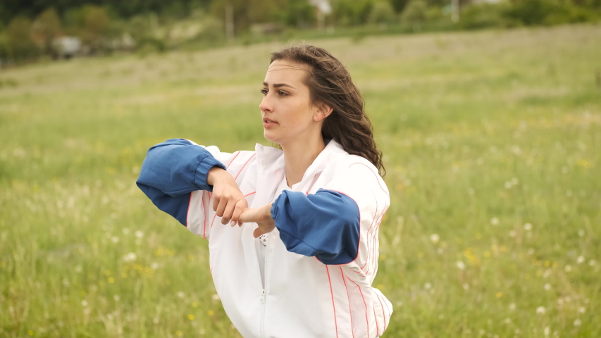 Beautiful brunette Caucasian appearance engaged in sports doing ski lifts in the park