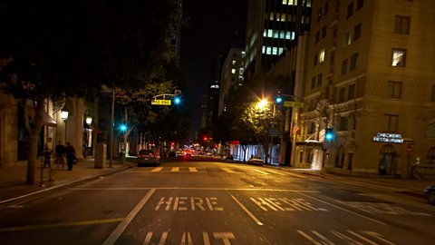 T/L WS POV Traffic on downtown streets at night / Los Angeles, California, USA