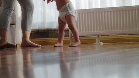 Close up of asian baby bare foot girl walking at home on the floor 