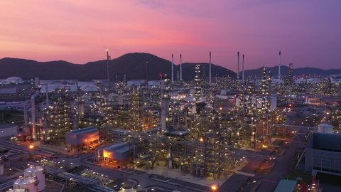 Aerial view at the refinery and oil tank at dusk. Business and petrochemical plants, oil storage tanks and for energy and steel pipes in Twilight time


