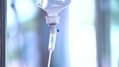 Closeup of IV drip in hospital, Intravenous saline solution, IV loading dose in ER room.