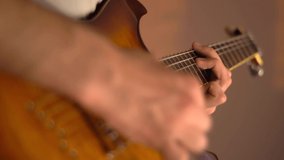 A young man plays the electric guitar at home. Golden amber sunburst guitar. Close-up. - Powered by Shutterstock - Get 15% off with code: PIKWIZARD15