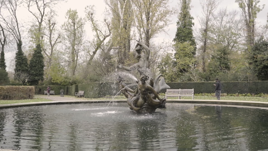 
Themed fountain in the park and a man walking