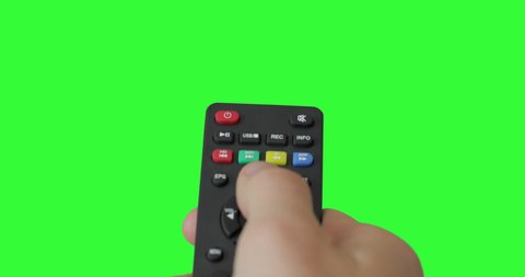Isolated Male hand with TV remote pressing button and changing, switch channels. Green screen. Place for your advertisement. Pack of Gestures. Using a remote control over keyed chroma key background