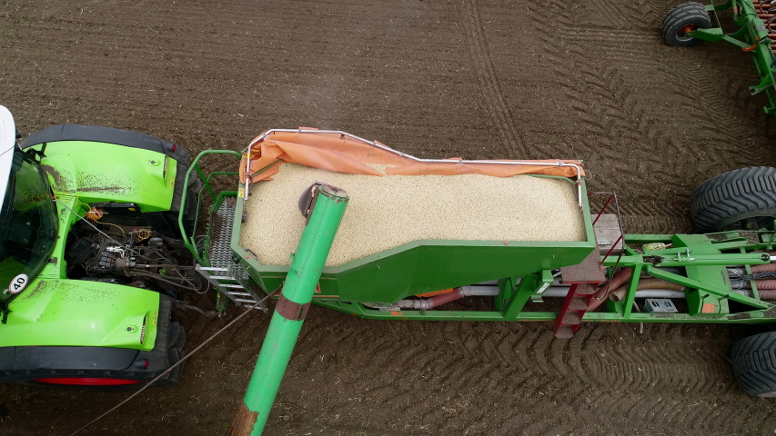 Aerial Rocket Shot, Going Out of the Ground. Sowing Equipment, Truck, Tractor. Wheat Crops, Planting the Soil, 4k
