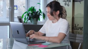 Millennial woman making video chat working from home using laptop. Young female online teacher conferencing on business call communicating by webcam on computer. Distance telework.