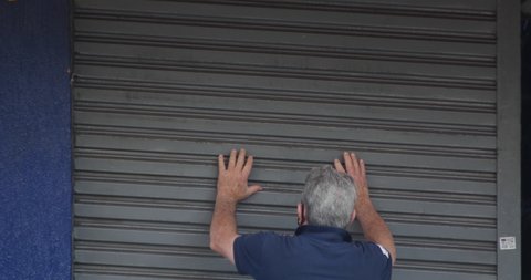 SAO PAULO, BRAZIL, May 28th 2020: Man opening shop store after coronavirus lockdown, Sao Paulo, Brazil , covid 19, quarantine, isolation, social distance