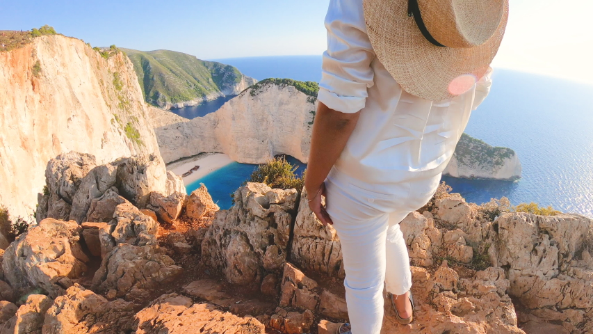 Young woman at Navagio Beach Shipwreck in Zante., taking pictures with vintage camera. Lagoon of Zakynthos island, Ionian Sea, Greece Royalty-Free Stock Footage #1053348611