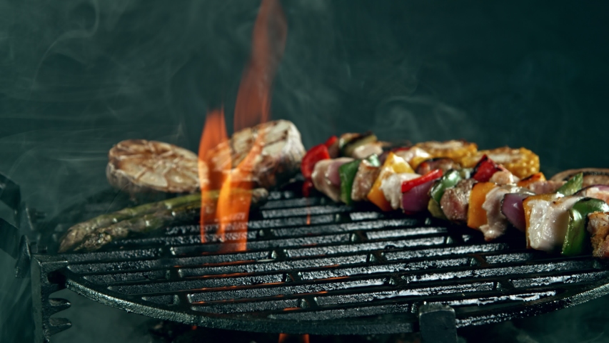 Super Slow Motion Shot of Fresh Skewer Falling on Grill at 1000 fps. Royalty-Free Stock Footage #1053361994