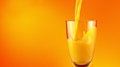 Super Slow Motion Shot of Pouring Fresh Orange Juice into Glass at 1000 fps.