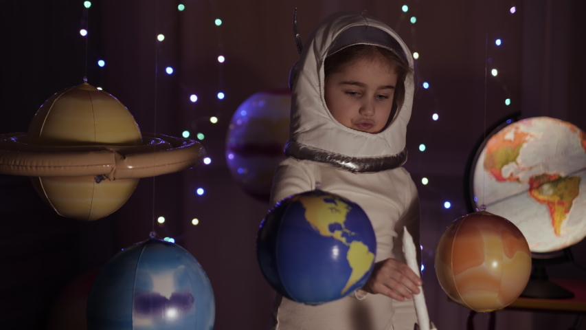 Space Travel Game Inspiration Spaceship. Little Kid Girl Astronaut Launching Toy Rocket From Spaceport Through Planets. Child Dreamer Playing With Toy Space Rocket Flying Among Planets. SLOW MOTION. Royalty-Free Stock Footage #1053364286