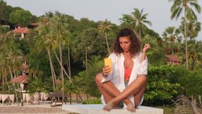 Caucasian woman take selfie on beach, smile  and laugh. Female blogger make video for instagram stories.