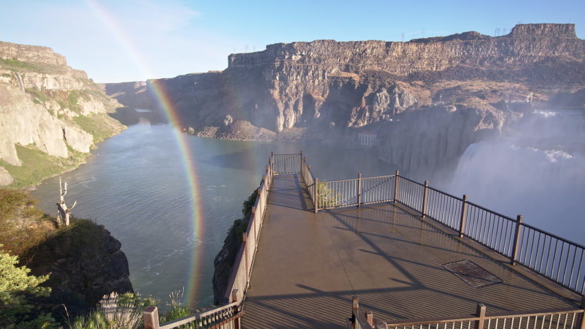 Panning view over empty viewpoint at Shoshone Falls Idaho viewing rainbow and waterfall in the Snake River Canyon.