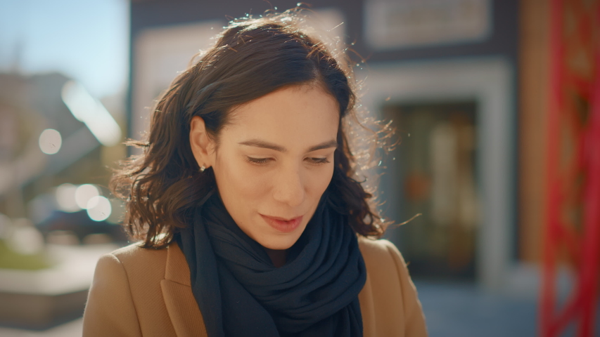 Portrait of a Gorgeous Dark Haired Hispanic Woman Smiling Charmingly while Standing in the Middle of Modern Urban City Landscape, Wearing Spring Coat. Happy Young Woman Enjoys Life | Shutterstock HD Video #1053374315